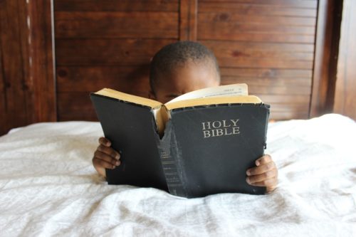 Child reading the bible, bonding