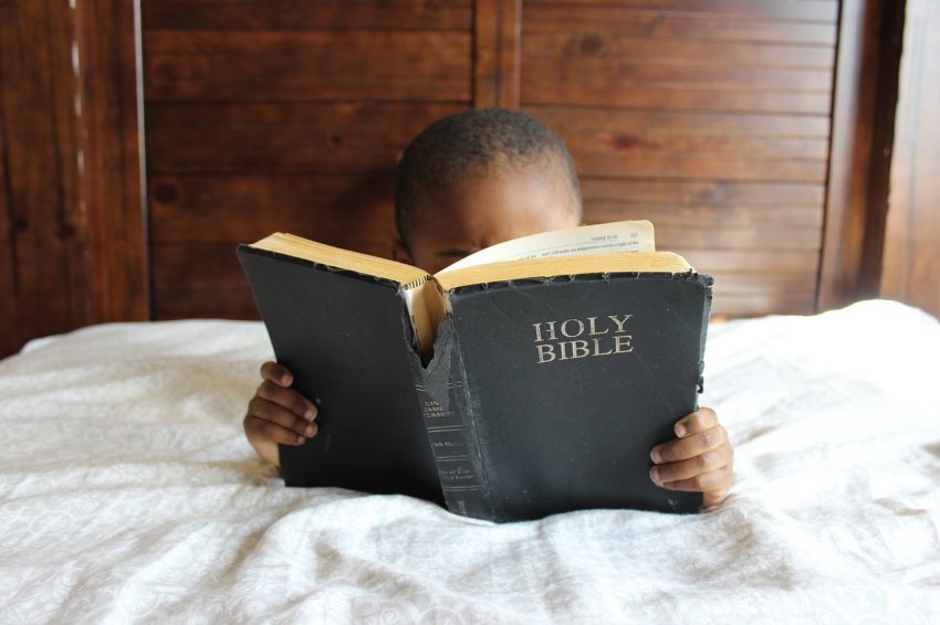 child learning the bible | Easter