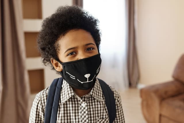 child with face mask
