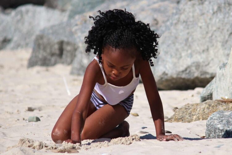 Toddler playing on the beach